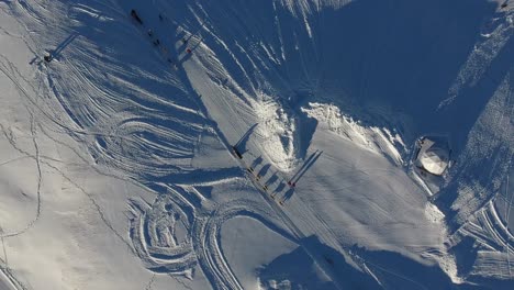 Flying-over-sled-dog-ride-in-a-snowy-landscape,-la-plagne-france.-Sunny-day